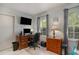 Office space features a wooden desk, rolling chair, and plenty of natural light from the window at 6570 Pebble Beach Crescent, Myrtle Beach, SC 29588