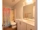 Bright bathroom with white vanity, tub-shower combo, and stylish mermaid scale curtain at 6936 Woodhaven Dr., Myrtle Beach, SC 29588