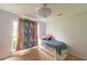 Bright bedroom with colorful unicorn curtains and whimsical chandelier lighting at 6936 Woodhaven Dr., Myrtle Beach, SC 29588