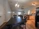 Dining area with stylish table and chairs with open view to kitchen and front door at 6936 Woodhaven Dr., Myrtle Beach, SC 29588