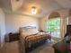 Comfortable bedroom with large window, vaulted ceilings and neutral tones at 6936 Woodhaven Dr., Myrtle Beach, SC 29588