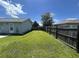 Fenced in backyard with green grass, patio and light gray siding at 706 Jamie Ln., Conway, SC 29526