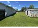 Fenced in backyard with green grass, a shed, patio, and light gray siding at 706 Jamie Ln., Conway, SC 29526