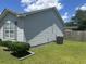 Side view of the house with light gray siding, green grass and a fenced yard at 706 Jamie Ln., Conway, SC 29526