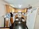 Spacious kitchen features wood cabinets, tile floors, and white appliances at 706 Jamie Ln., Conway, SC 29526