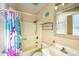 Compact bathroom featuring a shower-tub combo, patterned shower curtain, toilet, and a sink at 832 Villa Dr. # 832, North Myrtle Beach, SC 29582
