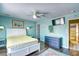 Cozy bedroom with blue walls, a ceiling fan, and a door that leads into another room at 832 Villa Dr. # 832, North Myrtle Beach, SC 29582