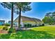 Exterior view of the community clubhouse with manicured lawn and garden at 832 Villa Dr. # 832, North Myrtle Beach, SC 29582