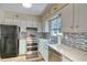 Charming kitchen with stainless steel appliances, mosaic backsplash, and ample cabinet space at 832 Villa Dr. # 832, North Myrtle Beach, SC 29582
