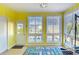 Sunroom featuring bright yellow walls, tile flooring, an exterior door, and natural light at 832 Villa Dr. # 832, North Myrtle Beach, SC 29582