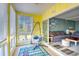 Bright sunroom with hanging chair, cheerful decor, and sliding glass doors to the living area at 832 Villa Dr. # 832, North Myrtle Beach, SC 29582