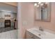 Modern bathroom with sleek vanity, mirror, and doorway to the kitchen at 850 Fairway Dr. # 904Ee, Longs, SC 29568