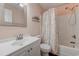 Well-lit bathroom features a shower-tub combination with decorative shower curtain and a single sink vanity at 850 Fairway Dr. # 904Ee, Longs, SC 29568