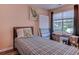 Cozy bedroom features a twin bed, a window, and personal belongings in boxes at 850 Fairway Dr. # 904Ee, Longs, SC 29568