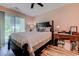Well-lit bedroom features a queen bed, a desk, and a sliding glass door leading to the outside at 850 Fairway Dr. # 904Ee, Longs, SC 29568
