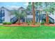 Low-angle, eye-level view of a condo exterior with stairs, green shutters, and landscaped grounds at 850 Fairway Dr. # 904Ee, Longs, SC 29568