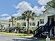 Charming condo exterior features white siding, black stairs, palm trees, and well-maintained landscaping at 850 Fairway Dr. # 904Ee, Longs, SC 29568