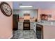 Modern kitchen equipped with black appliances, gray cabinets, granite counters, and stylish backsplash at 850 Fairway Dr. # 904Ee, Longs, SC 29568
