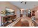 Open concept living area with decorative TV stand, dining table and chairs at 850 Fairway Dr. # 904Ee, Longs, SC 29568