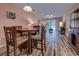 Open-concept living and dining area with wood-look floors and a sliding door at 850 Fairway Dr. # 904Ee, Longs, SC 29568