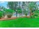 Community pool area featuring lush greenery, lounge chairs, and a secure fence at 850 Fairway Dr. # 904Ee, Longs, SC 29568