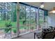 Enclosed porch overlooking a lush green lawn and landscaped yard at 850 Fairway Dr. # 904Ee, Longs, SC 29568