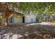 Exterior shot of a house featuring three garage doors and a spacious driveway surrounded by trees at 854 Falkirk St., Myrtle Beach, SC 29579