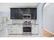 Well-appointed kitchen featuring stainless steel appliances, granite countertops, and white cabinets for a modern aesthetic at 854 Falkirk St., Myrtle Beach, SC 29579