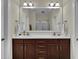 Bathroom vanity with double sinks and a large mirror, offering ample space and modern fixtures at 8855 Radcliff Dr. Nw # 50B, Calabash, NC 28467
