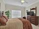 Inviting bedroom featuring a queen-size bed, a dresser, and a large window for natural light at 8855 Radcliff Dr. Nw # 50B, Calabash, NC 28467