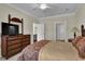 Bright bedroom featuring a decorative dresser and a glimpse into other areas of the home at 8855 Radcliff Dr. Nw # 50B, Calabash, NC 28467