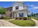 Attractive two-story townhome with red shutters, brick accents, and manicured landscaping on a sunny day at 8855 Radcliff Dr. Nw # 50B, Calabash, NC 28467