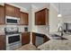 Granite counters and stainless steel appliances highlight this practical and efficient kitchen space at 8855 Radcliff Dr. Nw # 50B, Calabash, NC 28467
