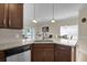 Open kitchen with granite countertops, stainless steel appliances, and views into the dining and living areas at 8855 Radcliff Dr. Nw # 50B, Calabash, NC 28467
