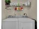 Laundry room featuring a washer, dryer, and storage shelving for supplies at 8855 Radcliff Dr. Nw # 50B, Calabash, NC 28467