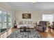 Comfortable living room features neutral tones, a plush sofa, and a sliding glass door at 8855 Radcliff Dr. Nw # 50B, Calabash, NC 28467