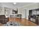 Open living area featuring hardwood floors, neutral color palette, and an entertainment center at 8855 Radcliff Dr. Nw # 50B, Calabash, NC 28467