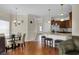 Open concept living area connecting kitchen, dining, and living areas with hardwood floors and natural light at 8855 Radcliff Dr. Nw # 50B, Calabash, NC 28467