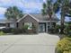 Inviting brick home featuring mature landscaping and a paved driveway at 1028 Cherry Tree Ln., North Myrtle Beach, SC 29582