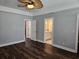The main bedroom has a ceiling fan, neutral walls, beautiful floors, and an ensuite bathroom at 1028 Cherry Tree Ln., North Myrtle Beach, SC 29582