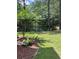 Lovely backyard with view of a pond, trees, and lush green grass at 124 Birch N Coppice Dr. # 1, Surfside Beach, SC 29575