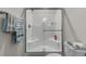 All-white shower with sliding glass door, plus convenient towel rack at 124 Birch N Coppice Dr. # 1, Surfside Beach, SC 29575
