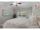 Cozy bedroom with carpet, ceiling fan, full-sized bed, and large window at 124 Birch N Coppice Dr. # 1, Surfside Beach, SC 29575