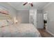 Bedroom with carpet, ceiling fan, full-sized bed, and entrance to storage space at 124 Birch N Coppice Dr. # 1, Surfside Beach, SC 29575