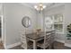 Cozy dining area with contemporary chandelier and table next to a window at 124 Birch N Coppice Dr. # 1, Surfside Beach, SC 29575