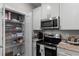 Kitchen area with stainless appliances, granite countertops, and open pantry at 124 Birch N Coppice Dr. # 1, Surfside Beach, SC 29575