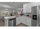 Open kitchen featuring white cabinets, granite counters, and stainless steel appliances at 124 Birch N Coppice Dr. # 1, Surfside Beach, SC 29575