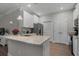 Well-lit kitchen featuring white cabinets, granite counters, and stainless steel appliances at 124 Birch N Coppice Dr. # 1, Surfside Beach, SC 29575