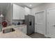 Well-lit kitchen featuring white cabinets, granite counters, and stainless steel appliances at 124 Birch N Coppice Dr. # 1, Surfside Beach, SC 29575