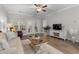 Spacious living room with patio doors, hardwood floors, decor, ceiling fan, and TV at 124 Birch N Coppice Dr. # 1, Surfside Beach, SC 29575